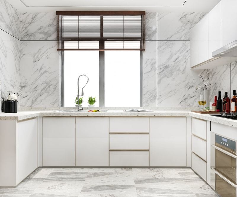 Representative white kitchen with marble-finish walls and window